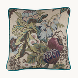 Photo of a floral cushion, natural linen base cloth with dusty purple , navy, powder blue and verdigris coloured large scale flowers
