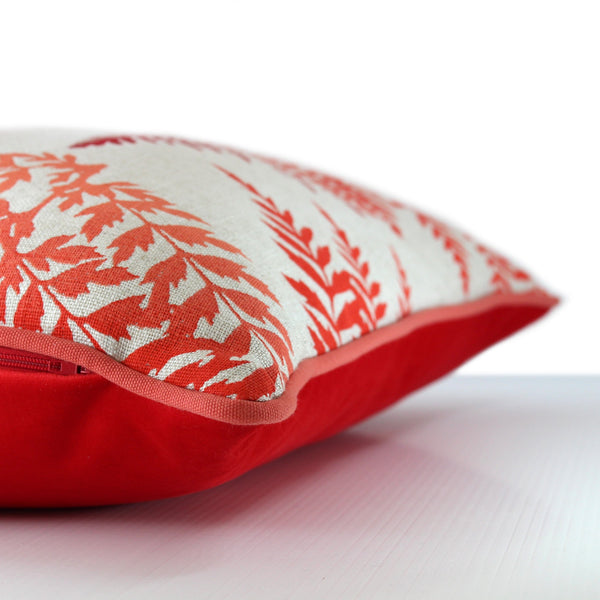 Side view of a cushion with screen printed bright red coloured fern leaves