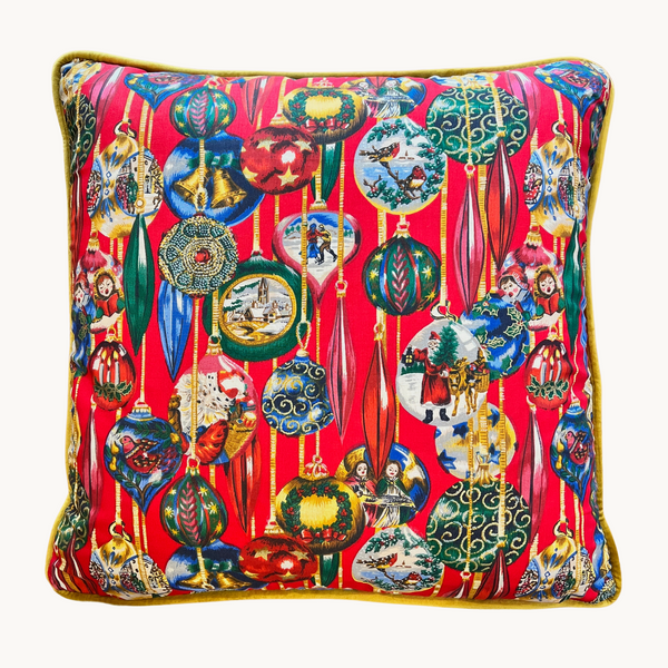 Photo of a Christmas cushion made from a vintage fabric with highly decorative baubles in red, blue, emerald, and gold