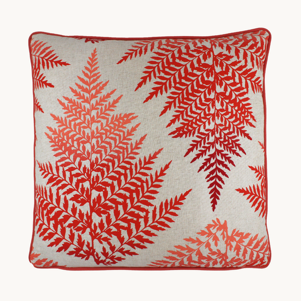 Photo of a cushion with screen printed bright red coloured fern leaves