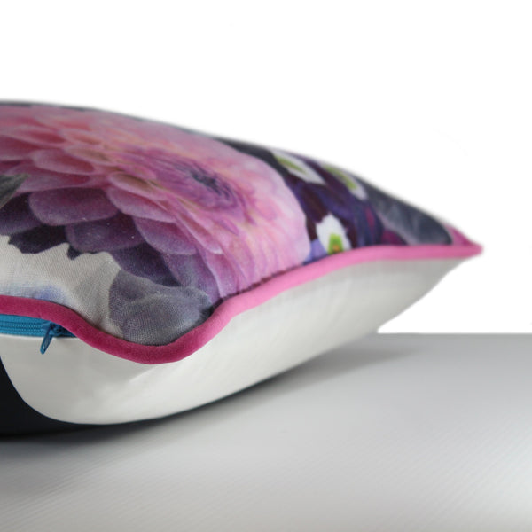 Side view of a large scale printed linen floral cushion with bright purple, hot pink, cobalt and lime coloured flowers
