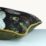 Sideshot of a square cushion with a black background and sepia toned dahlias