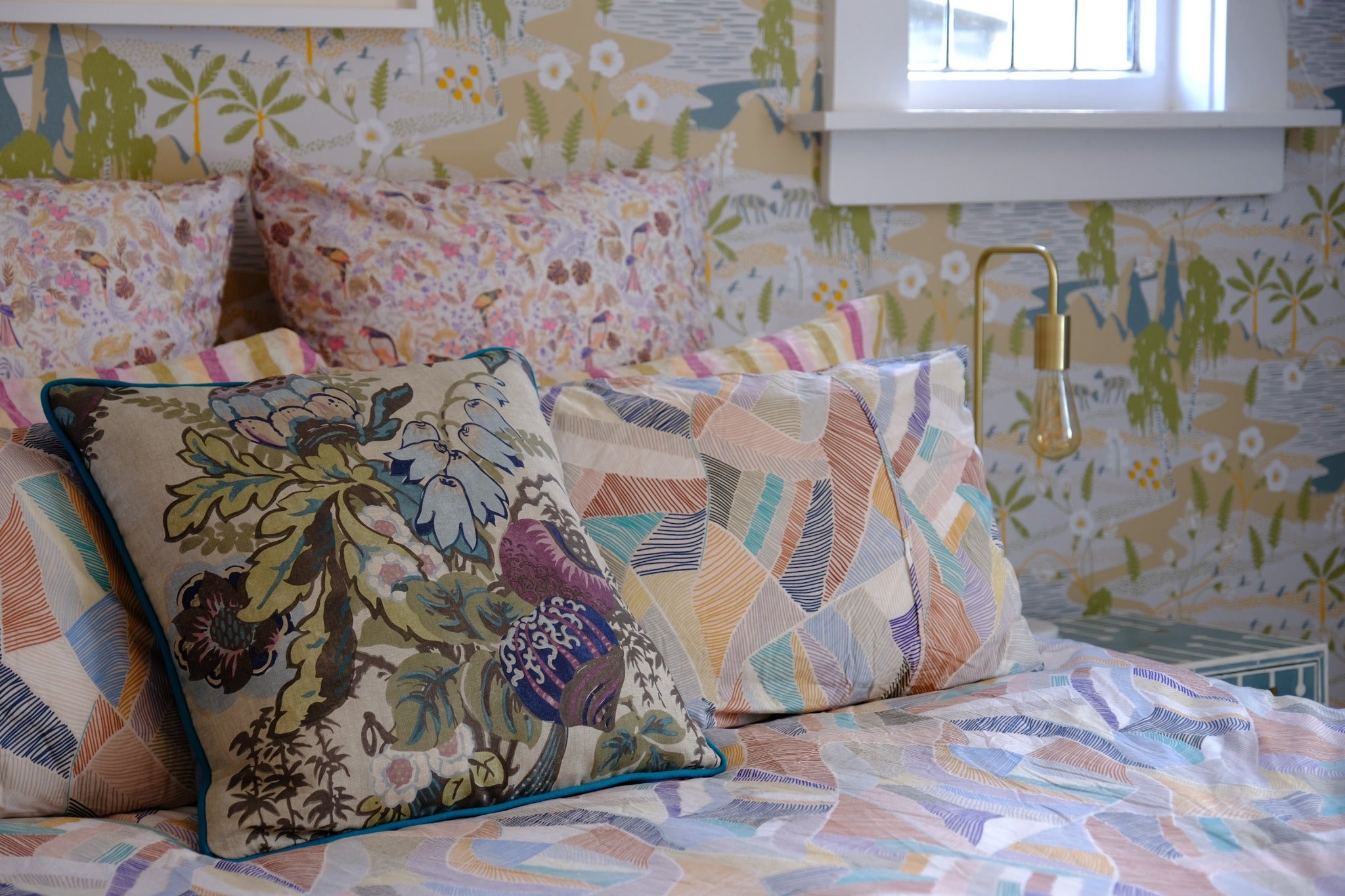 Photo of a bed setting with floral cushion 