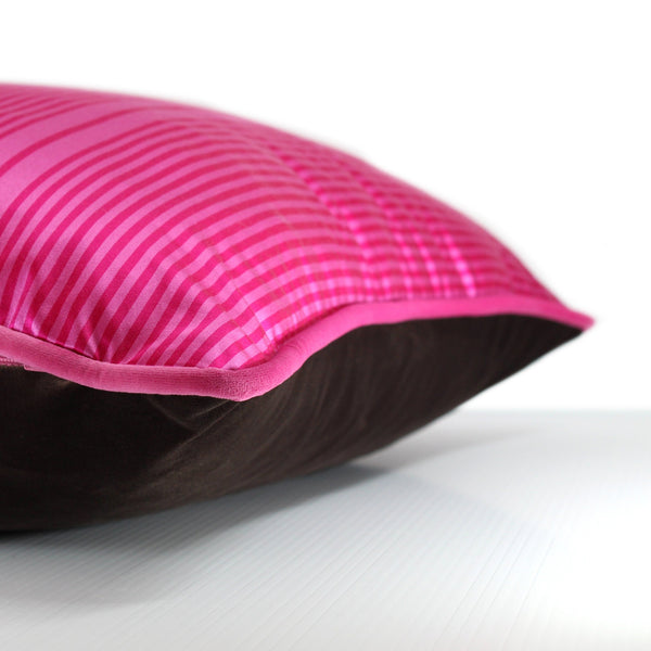 Side view of a hot pink, chocolate and white barcode stripe silk blend cushion