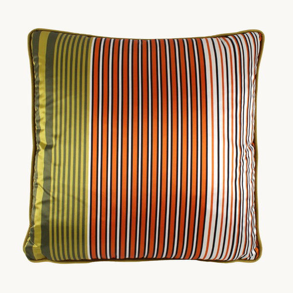 Photo of a cushion with an orange, white, green and black barcode like stripe 