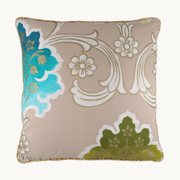 Photo of a cushion - a large scale scrolled hand painted style damask design with a tea coloured background and white, green, aqua and metallic gold