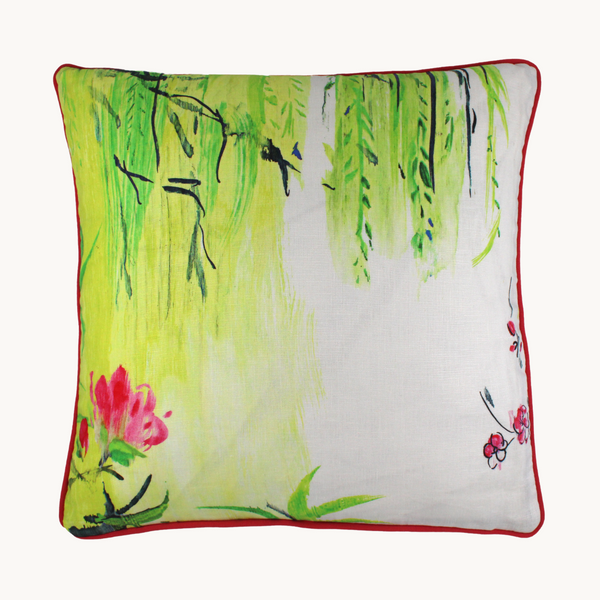 Photo of a linen cushion in a painterly design with bright yellow, white, lime green, hot pink and black