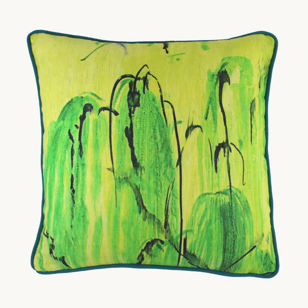 Photo of a linen cushion in a painterly design with bright yellow, white, lime green and black