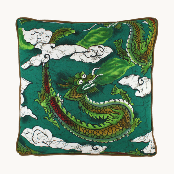 Photo of a cushion with emerald green stylised dragons and clouds
