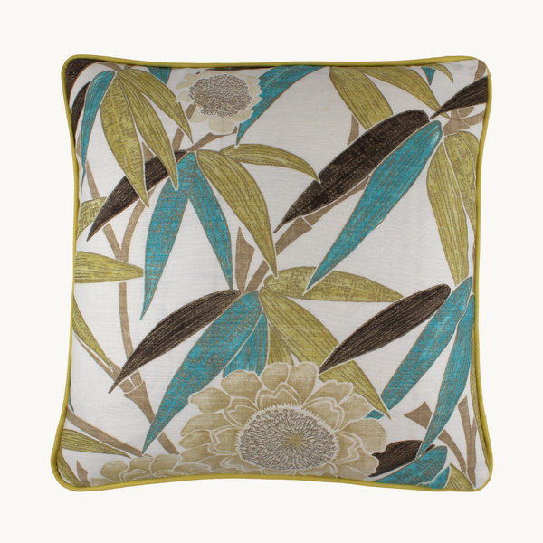 Photo of a leafy cushion with a white background and aqua and chartreuse long narrow leaves