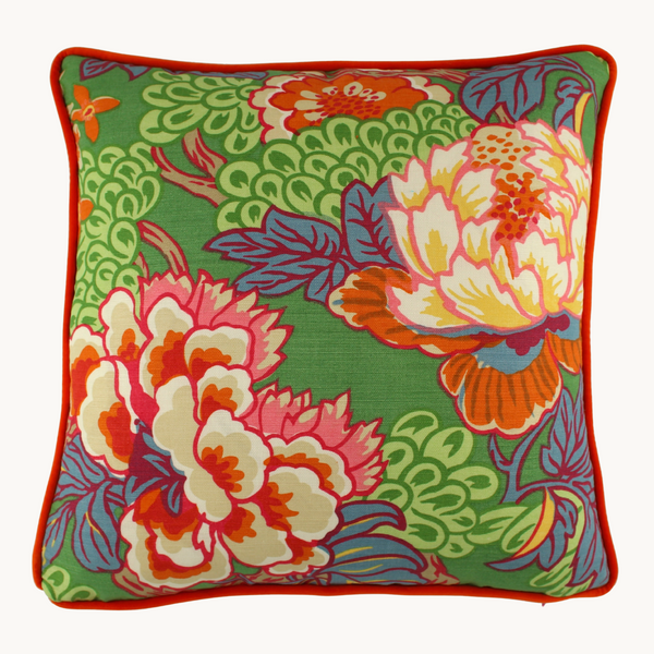 Green cushion with bright orange and pink oriental floral design