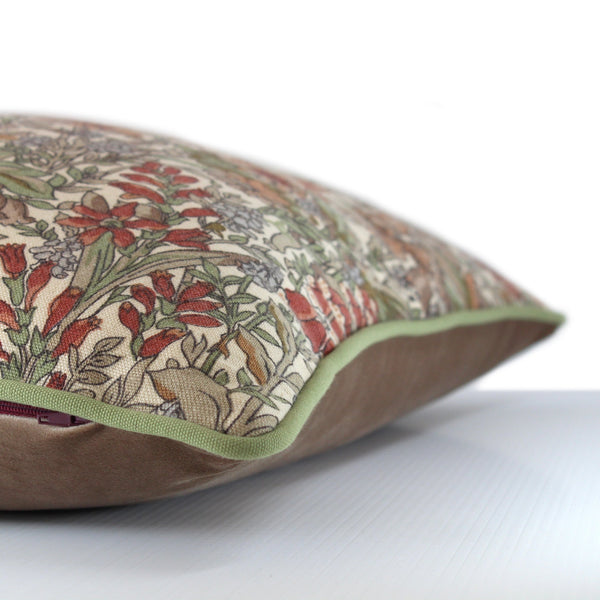 Side view of a cushion in a small scale Liberty floral in taupes, persimmon and brick colours