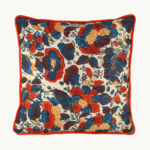 Photo of a cushion in a joyful combination of bright orange and navy blue in a painterly floral pattern