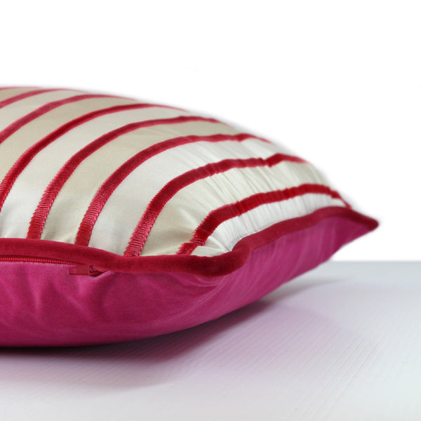Side view of a pink velvet striped cushion