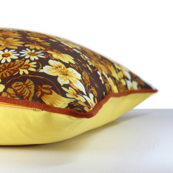 Side view of a 1970s inspired medium scale floral in bright yellow and ochre with a chocolate brown background