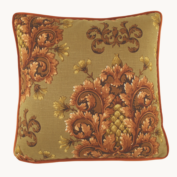 Photo of a square cushion with a khaki background and baroque scrolled motifs in a chestnut colour