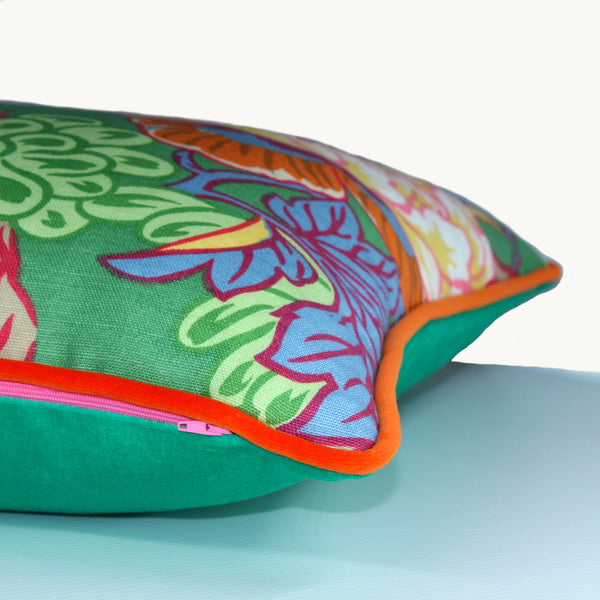side shot of a bright green cushion with an orange and pink oriental floral design