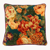 Vibrant velvet floral cushion in orange, rust, teal, aubergine and peach.