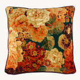 Sideshot ofPhoto of a velvet floral cushion in teal, orange, rust, aubergine and peach.