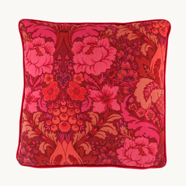 Photo of a cushion made from a punchy vintage damask in hot pink, coral and red