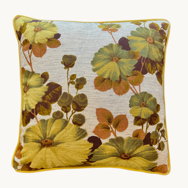 Cushion made from a large scale vintage floral  in yellow, khaki, olive and cinnamon
