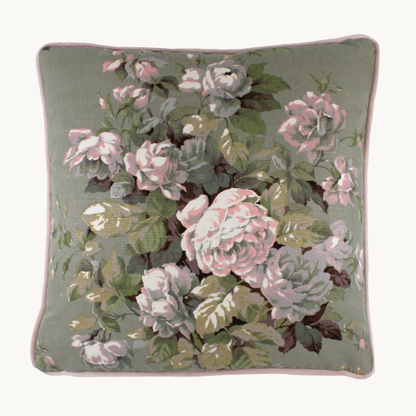 Photo of a cushion made from a vintage linen with a whimsical floral boquet of roses in soft pinks, duck egg blue and sage green