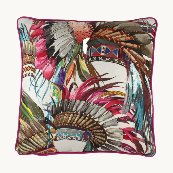 Photo of a cushion made from a printed linen with colourful native american indian feather headdresses and fuschia piping