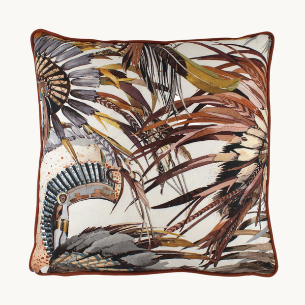 Photo of a cushion made from a printed linen with natural coloured native american indian feather headdresses and rust linen piping
