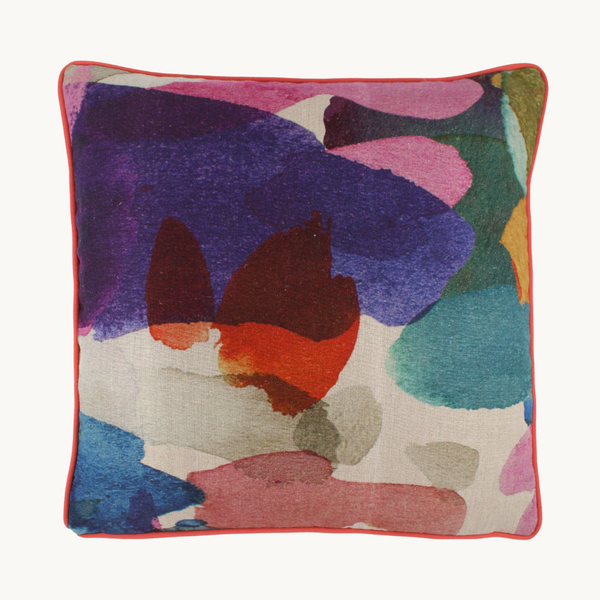 Photo of a colourful abstract cushion with royal purple, tomato, turquoise, cobalt, pink and forest green painterly large scale splotches